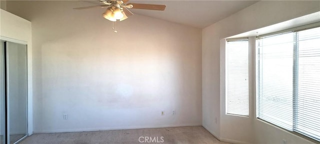 unfurnished room featuring light colored carpet and ceiling fan