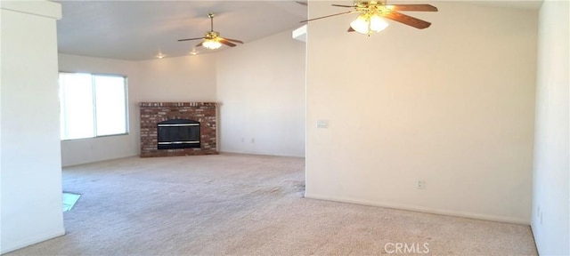 unfurnished living room with ceiling fan, light colored carpet, vaulted ceiling, and a brick fireplace