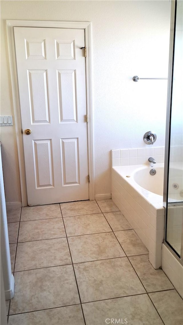 bathroom with separate shower and tub and tile patterned flooring