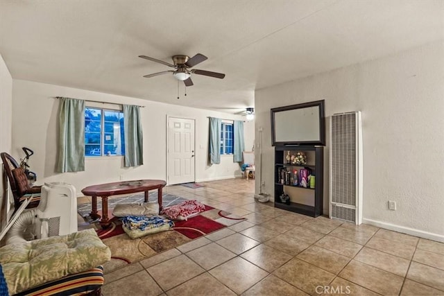 tiled living room with ceiling fan