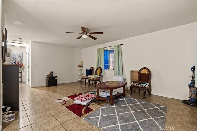 living area featuring tile patterned floors and ceiling fan