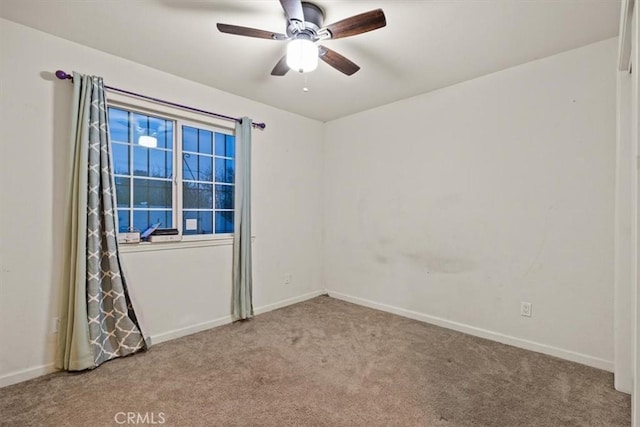 unfurnished room with ceiling fan and light colored carpet