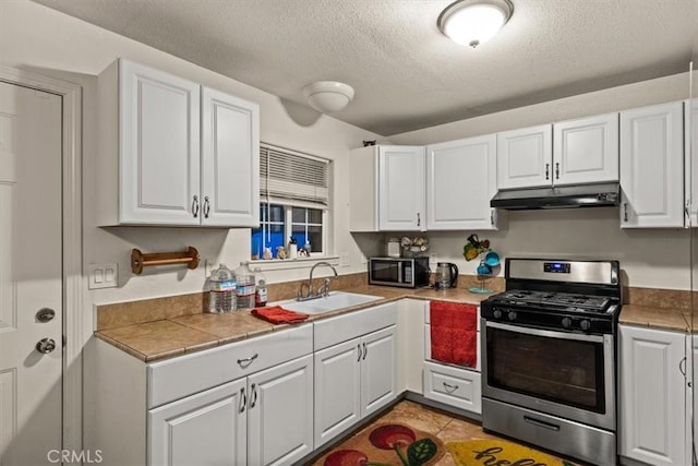 kitchen featuring a textured ceiling, sink, white cabinetry, and stainless steel appliances