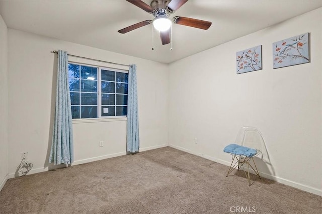 carpeted empty room featuring ceiling fan