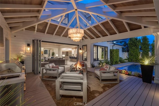 exterior space featuring a fenced in pool and an outdoor living space with a fire pit
