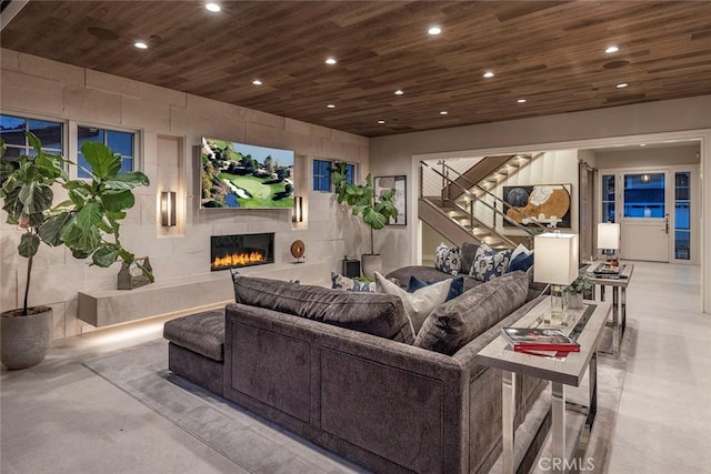 cinema room with a tile fireplace, wooden ceiling, and finished concrete flooring