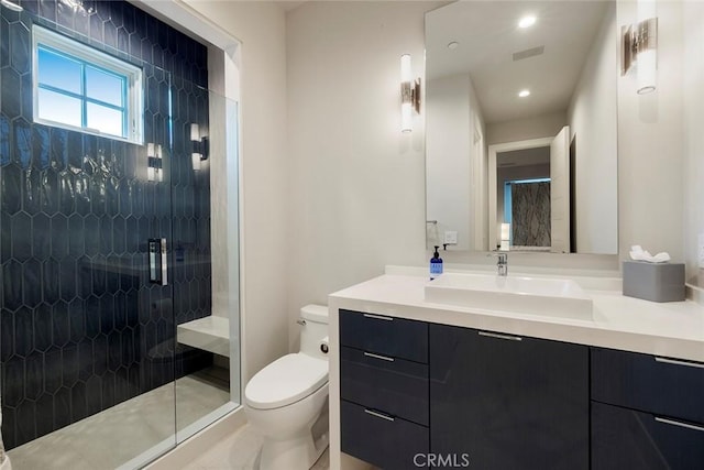 full bathroom with recessed lighting, vanity, a stall shower, and toilet