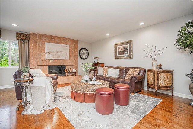 living room featuring hardwood / wood-style floors and a tile fireplace