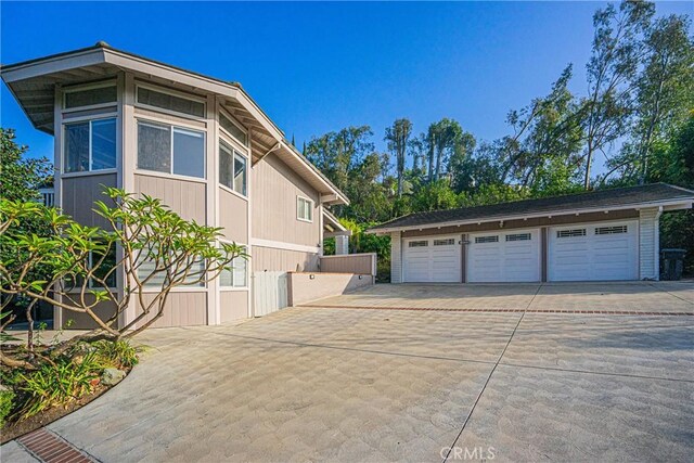 view of side of home featuring a garage and an outdoor structure