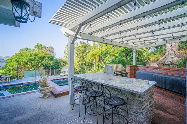 view of patio / terrace featuring an outdoor bar, a pergola, a swimming pool, a grill, and exterior kitchen