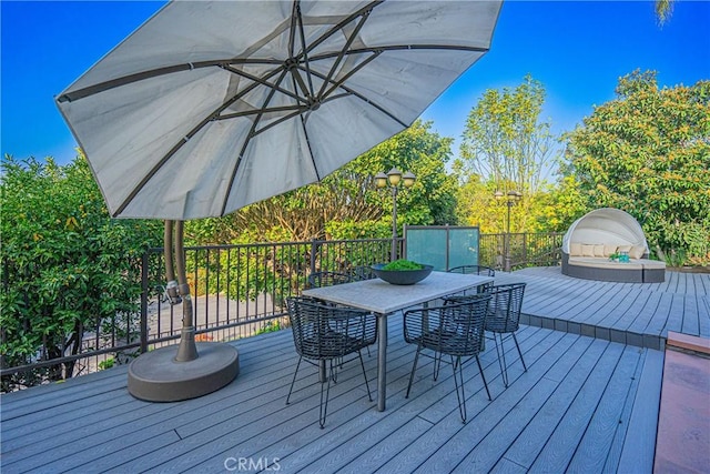 wooden terrace featuring outdoor dining area