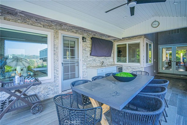 view of patio / terrace with french doors, outdoor dining area, visible vents, ceiling fan, and a sink