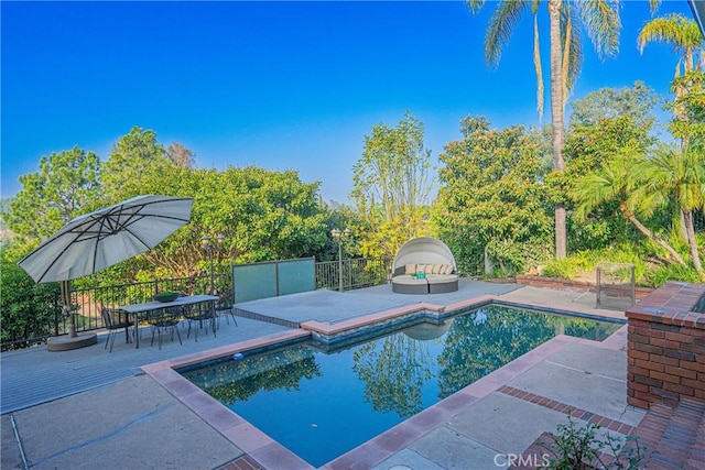 view of swimming pool featuring fence, a fenced in pool, and a patio