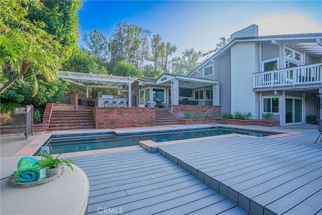 view of pool with stairway, area for grilling, and a pergola