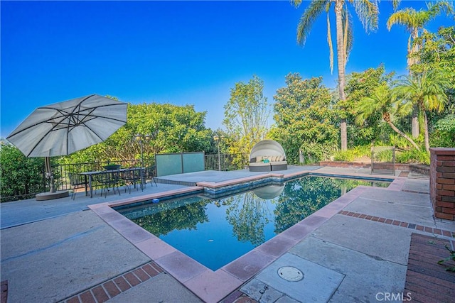 outdoor pool featuring a patio area and fence