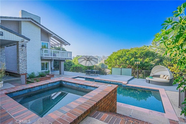 view of swimming pool featuring an in ground hot tub and a patio area