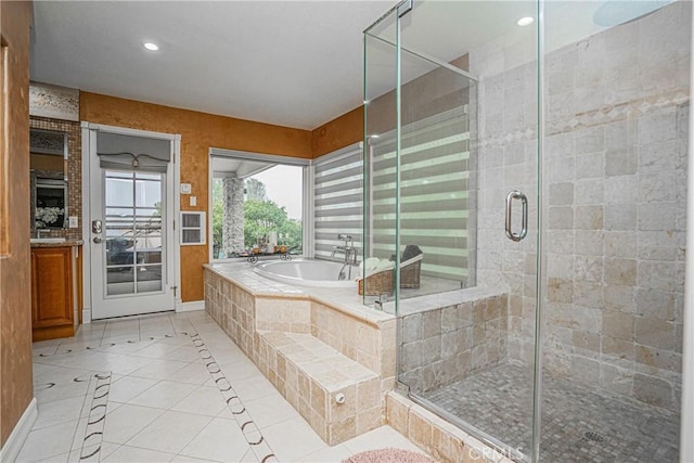 full bath featuring recessed lighting, a garden tub, a shower stall, and tile patterned floors