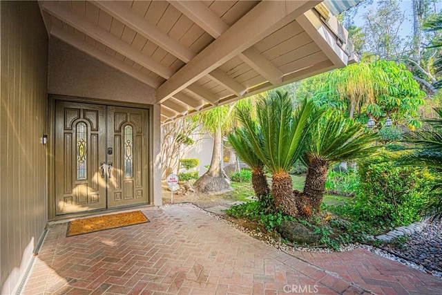 property entrance with a patio and french doors