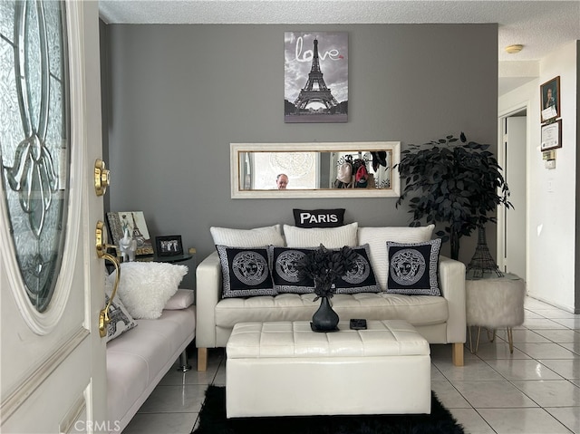 living room with light tile patterned floors and a textured ceiling