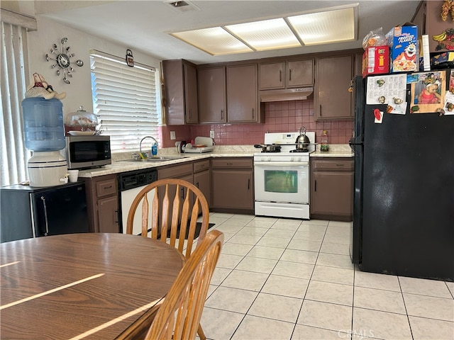 kitchen featuring white appliances, sink, light tile patterned floors, tasteful backsplash, and dark brown cabinets