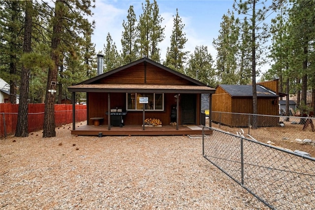 rear view of property featuring an outdoor structure