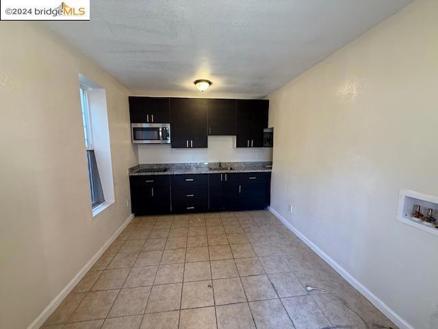 kitchen with sink and light tile patterned floors