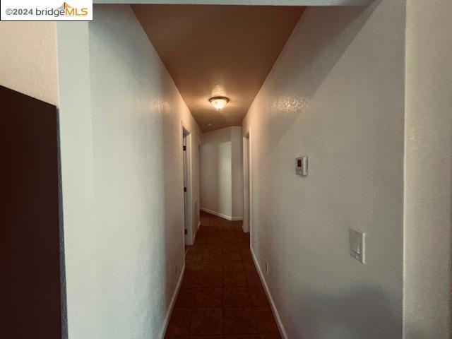 corridor with dark tile patterned floors