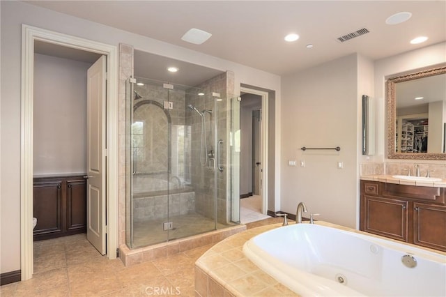 bathroom featuring tile patterned flooring, separate shower and tub, and vanity