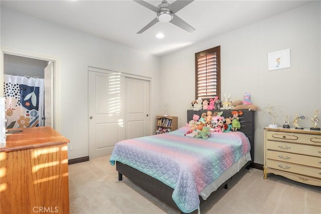 carpeted bedroom featuring ceiling fan and a closet