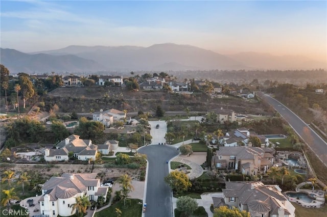 aerial view at dusk featuring a mountain view