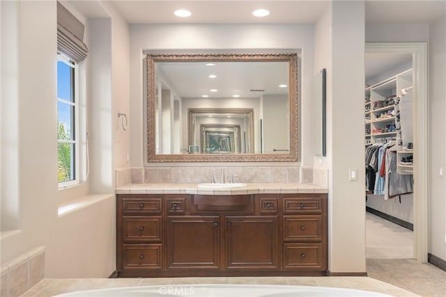 bathroom featuring vanity and decorative backsplash