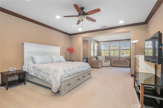 carpeted bedroom with ceiling fan and crown molding