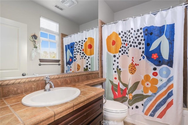 bathroom featuring shower / tub combo, visible vents, vanity, and toilet