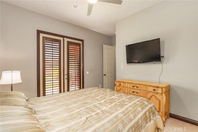 bedroom featuring light carpet and ceiling fan