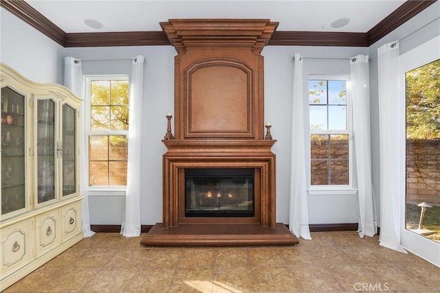 unfurnished room featuring a large fireplace and crown molding