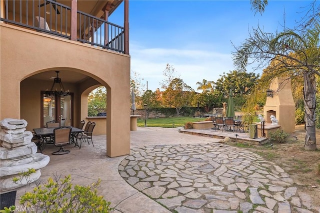 view of patio featuring exterior fireplace