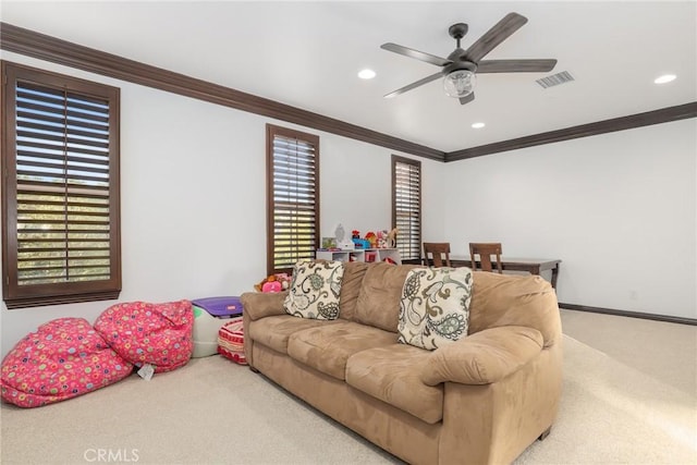 living room featuring crown molding, carpet flooring, a healthy amount of sunlight, and ceiling fan