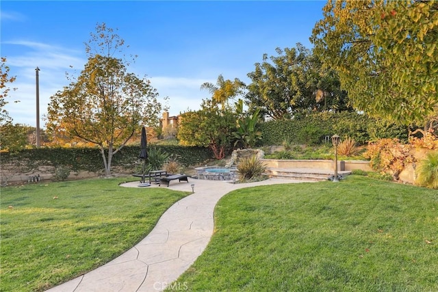 view of home's community with a patio area, a fenced backyard, and a yard