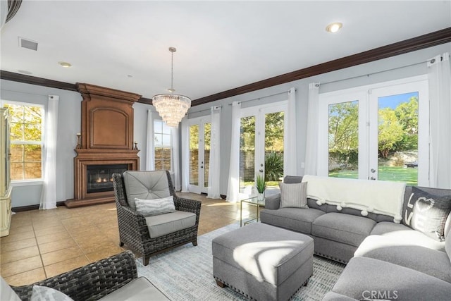 sunroom / solarium with a chandelier, french doors, and a fireplace