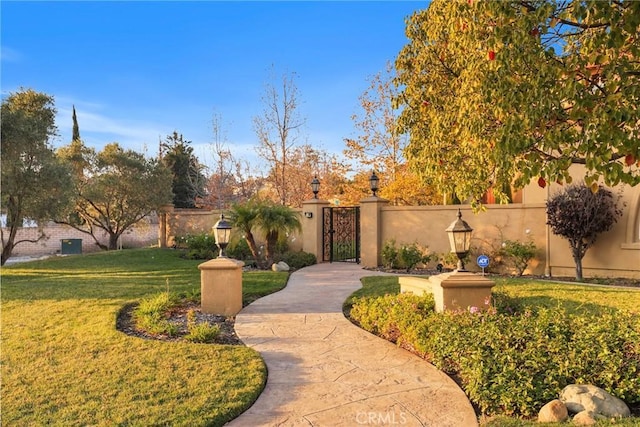 exterior space featuring a gate, a lawn, and fence