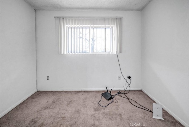 carpeted spare room featuring a textured ceiling