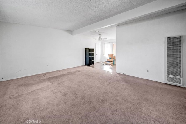 unfurnished living room with beam ceiling, a textured ceiling, carpet floors, and ceiling fan