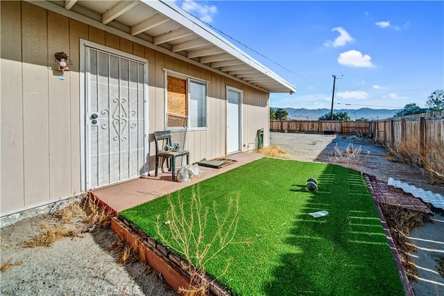 view of yard featuring a mountain view and a patio