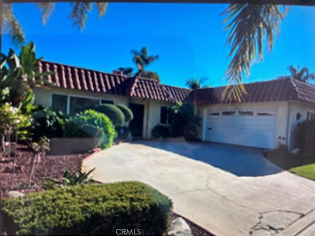 mediterranean / spanish-style home featuring a garage