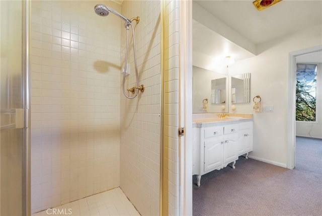 bathroom with vanity and tiled shower