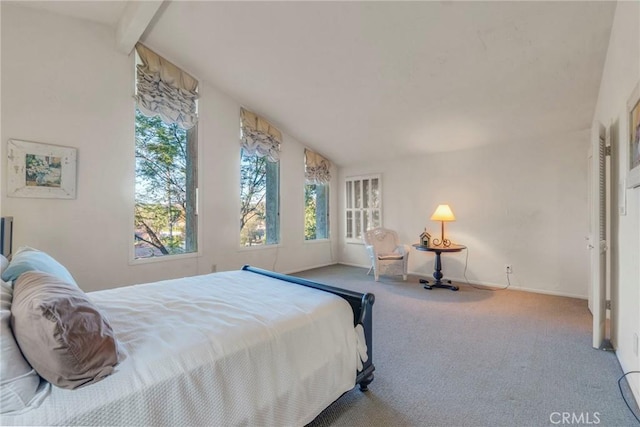 carpeted bedroom with lofted ceiling with beams