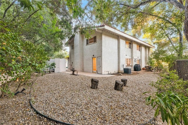 view of side of property featuring a patio and cooling unit