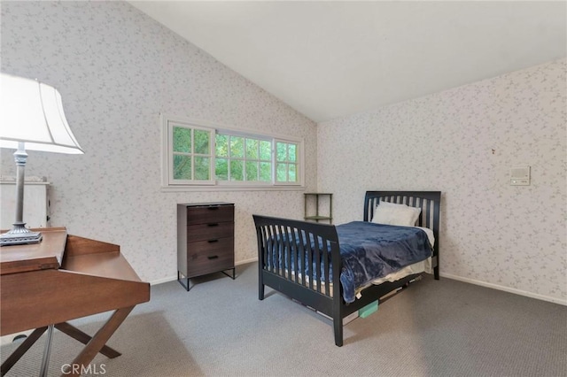 carpeted bedroom with lofted ceiling