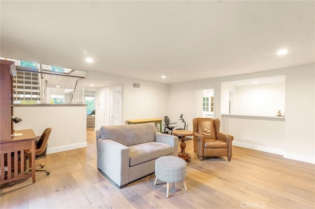 living room featuring a wealth of natural light and light hardwood / wood-style floors