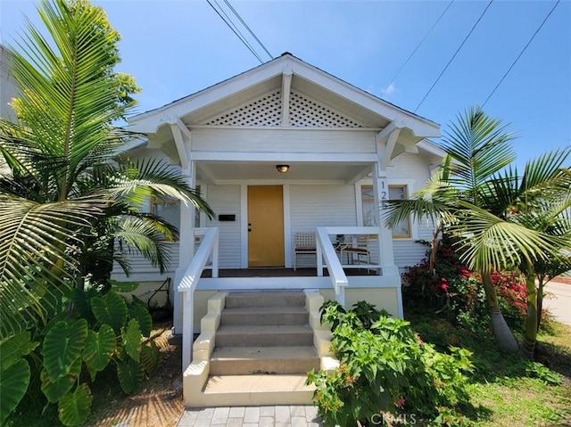 view of exterior entry with a porch